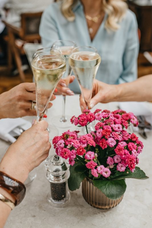 Guests raising a glass at Coq & Bull