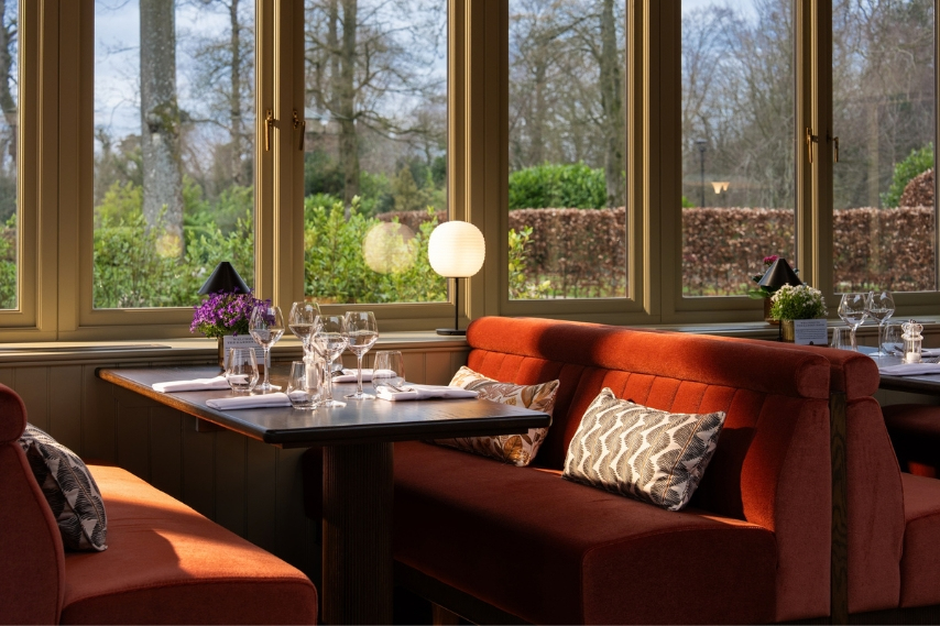 Garden Room interior overlooking the gardens at Coq & Bull