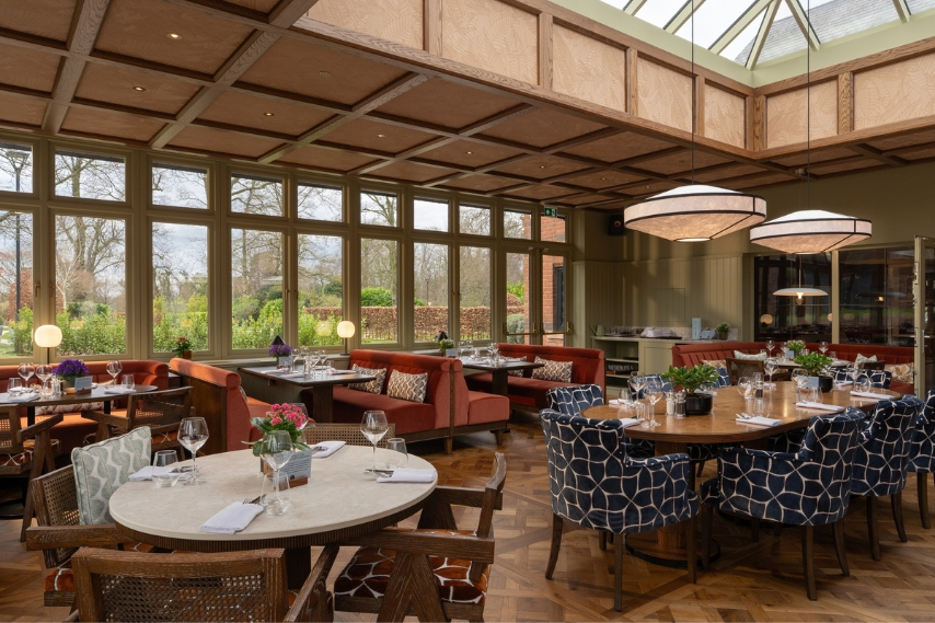 Tables set for dining in the Garden Room at Coq & Bull