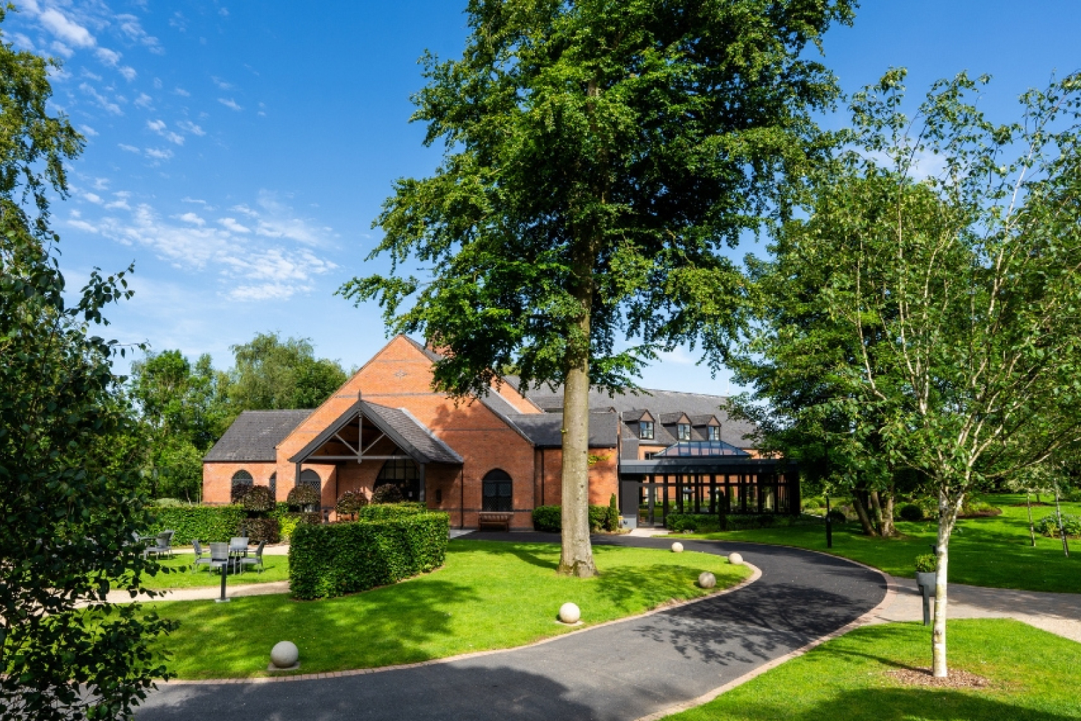 Clandeboye Lodge hotel entrance surrounded by woodland gardens in Northern Ireland