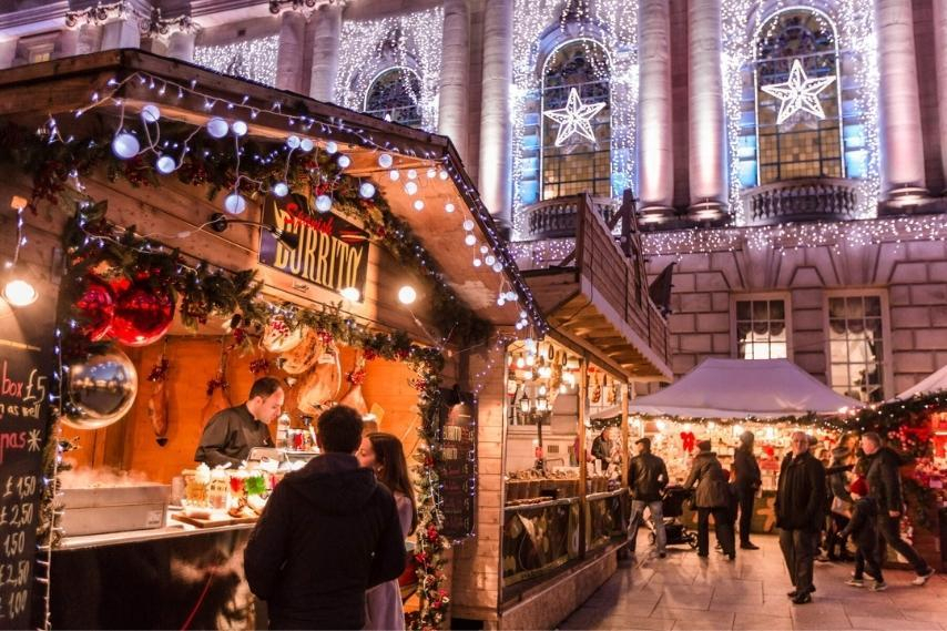 Christmas market stalls decorated with festive lights, a seasonal thing to do in Northern Ireland.