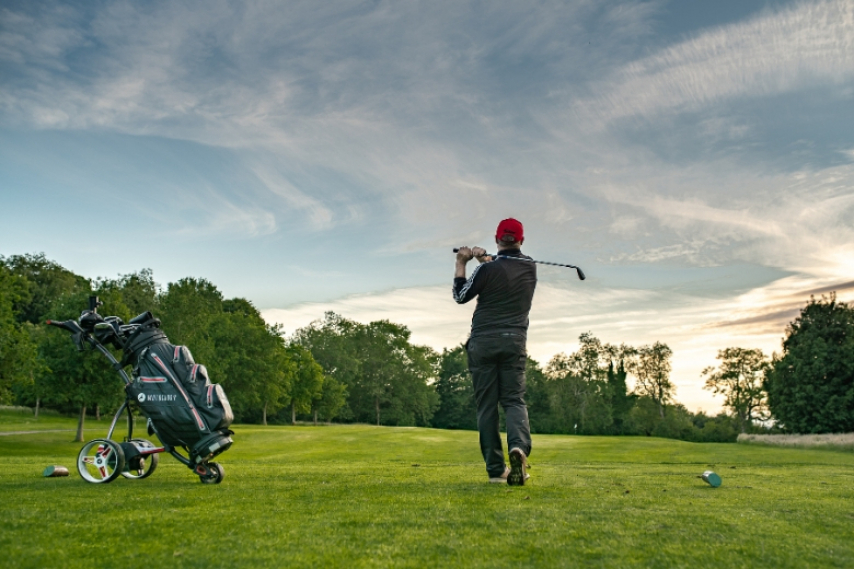 A person playing golf, a popular thing to do in Bangor Northern Ireland.